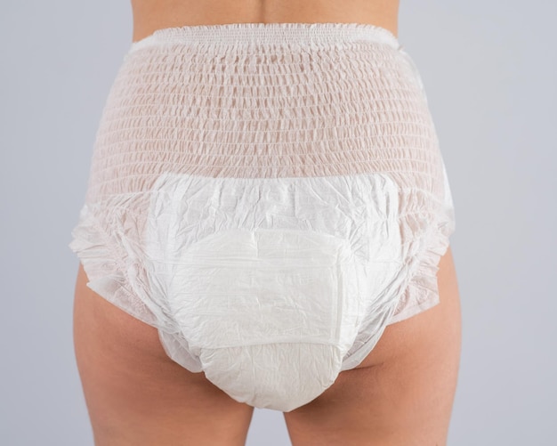 midsection of woman with towel against white background