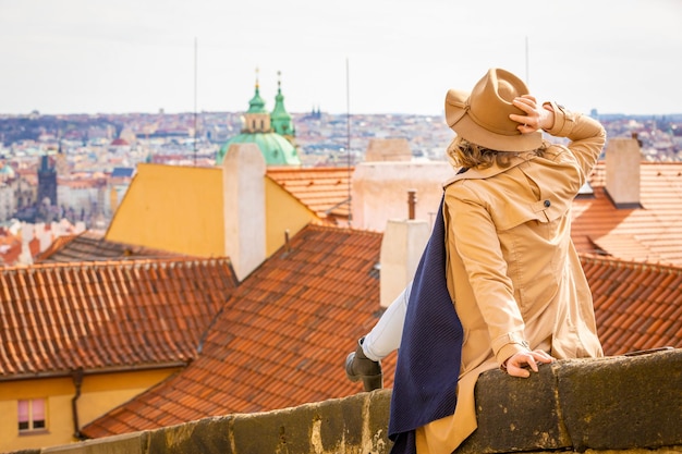 Midsection of woman with umbrella against sky in city