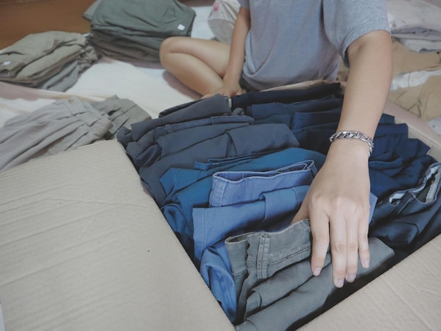 midsection of women sitting on bed