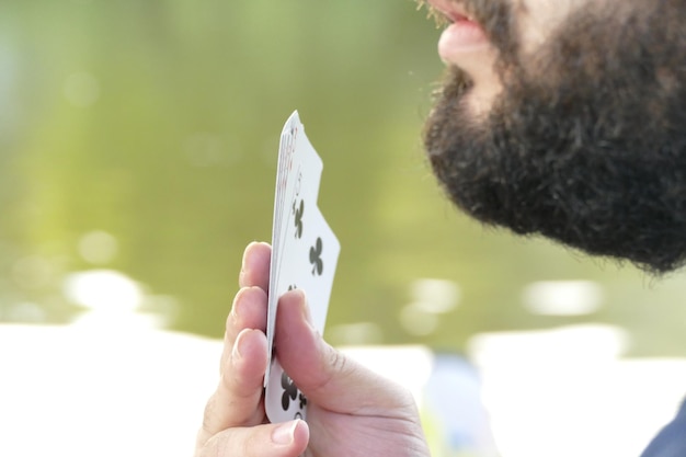 Photo midsection of young man playing cards