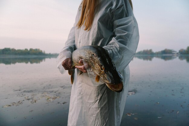 Photo midsection of young woman holding fish