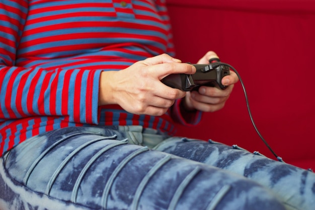 Midsection of young woman playing video games