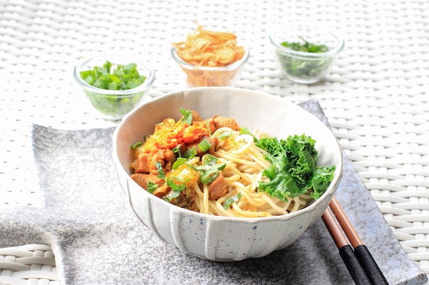 Mie Ayam, Indonesian Popular Street Food with Noodle, Chicken, and Green Vegetables with Delicious Broth