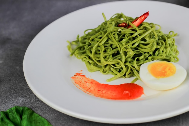 ミーゴレン目玉焼きと野菜を皿に盛り付けた焼きそば