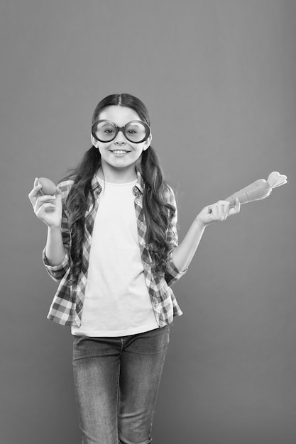 Might be yummy child on easter egg hunt happy easter preparing for Easter small girl wear party glasses little kid in hold carrot and painted egg spring holiday celebration Easter eggs