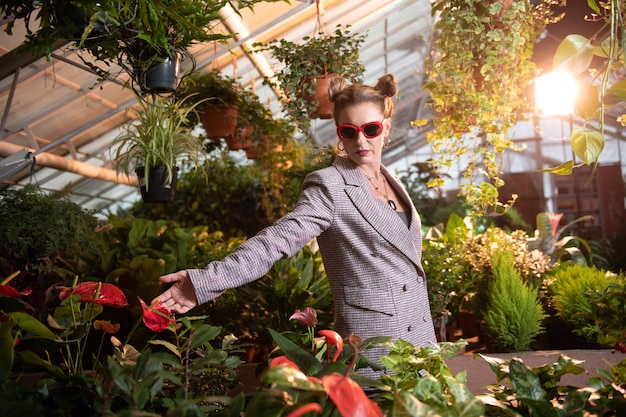 Foto mijn bloembed. mooie aangename vrouwen die naar haar bloemen kijken terwijl ze bij het bloembed staan