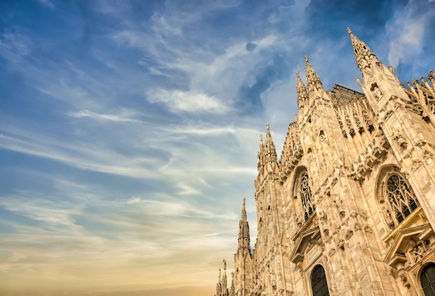 Milan Cathedral (Duomo di Milano) with copy space for text. Blue sky background and sunset light.