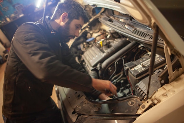 MILAN ITALY 24 APRIL 2022 Mechanic repairs car detail