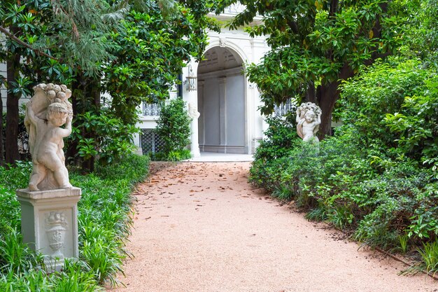 Milan Italy Circa June 2021 Italian Villa entrance with garden Luxurious green exterior