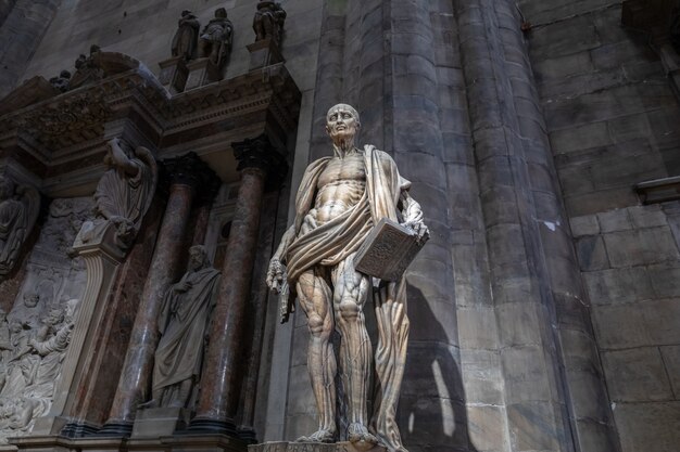 Milan, Italy - June 27, 2018: Closeup marble sculpture in Milan Cathedral (Duomo di Milano) is the cathedral church of Milan