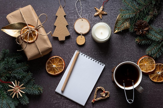 Foto milieuvriendelijke en handgemaakte kerstversieringen, een blanco notitieboekje op een donkere achtergrond