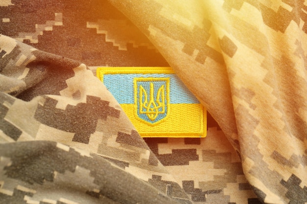 Military camouflage fabric with ukrainian flag on uniform chevron