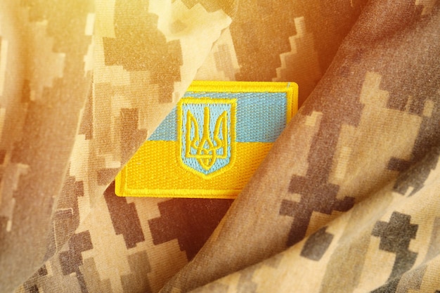 Military camouflage fabric with ukrainian flag on uniform chevron