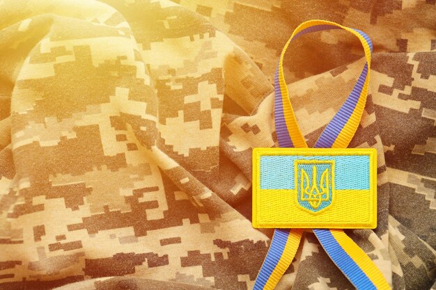 Military camouflage fabric with ukrainian flag on uniform chevron