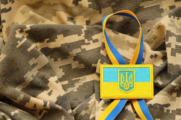 Military camouflage fabric with ukrainian flag on uniform chevron