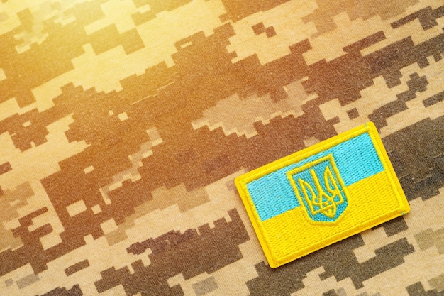 Military camouflage fabric with ukrainian flag on uniform chevron