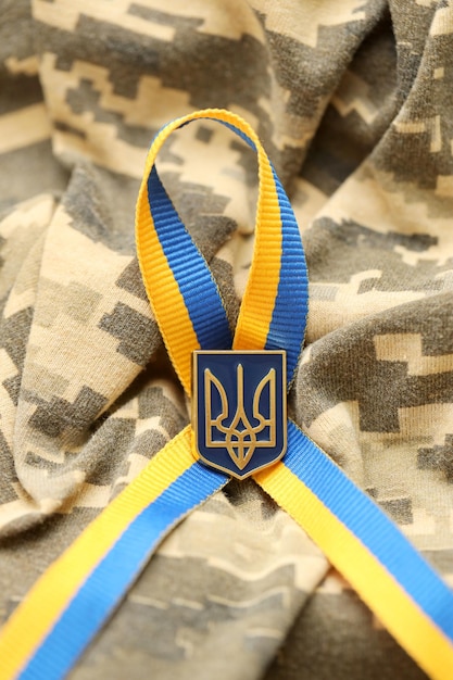 Military camouflage fabric with ukrainian stripes on ribbon