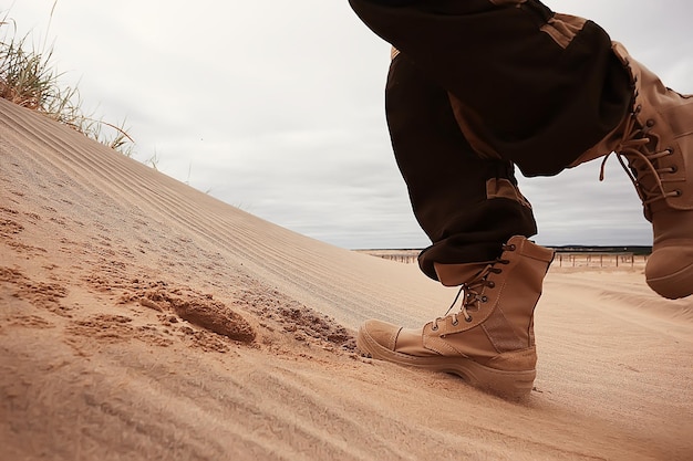 Military exercises in the desert / legs in army boots, soldiers\
of the desert