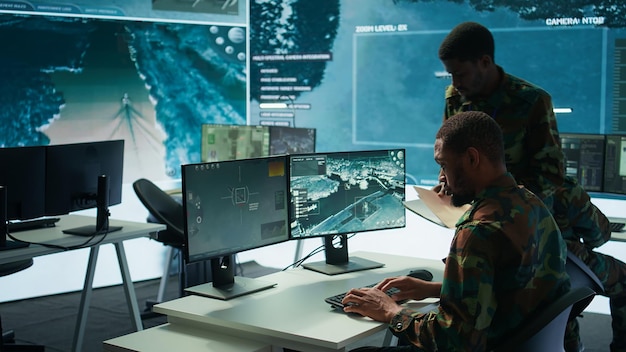 Military experts in mission control center use modern technology on computer