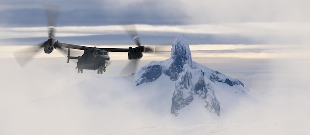 Military helicopter flying over the mountain peaks