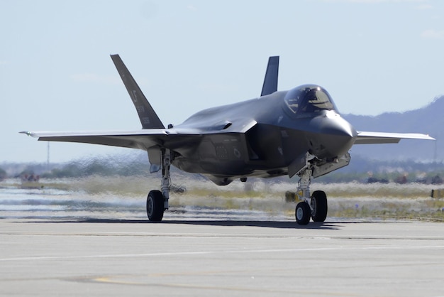 Photo a military jet is on the runway with the word f - 35 on the side.