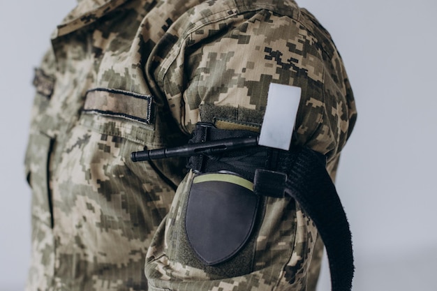 A military man demonstrates a combat medical tourniquet to stop blood during first aid Instructions for combat tactical equipment