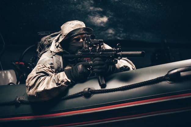 Military man in full combat ammunition is following a poacher in a boat with a flasher.