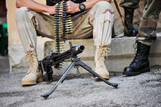 Military man with bullets and machine gun