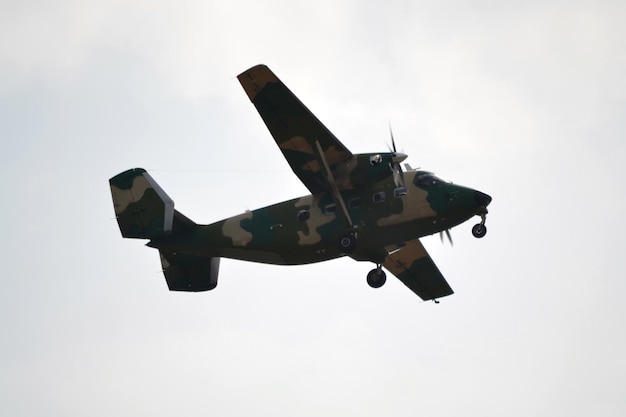 Military propeller plane flying side view