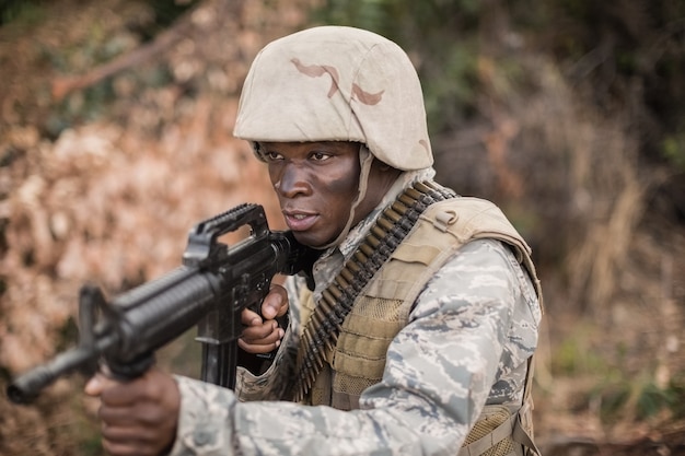 Military soldiers during training exercise with weapon at boot camp