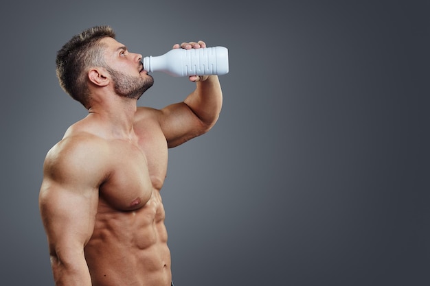 Milk bottle in the hands of a sports person