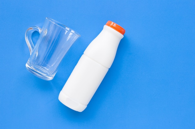 Milk bottle with glass on white