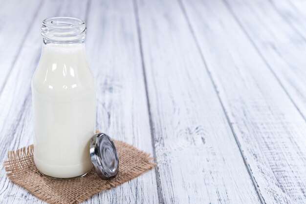 Milk on bright wooden background