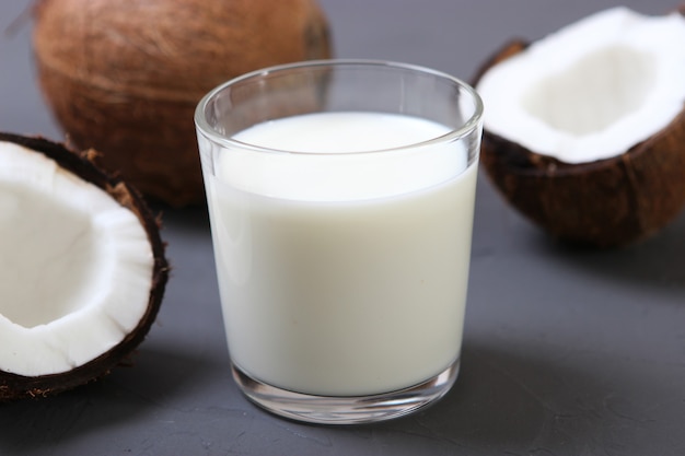 Milk and broken coconuts on the table vegetable milk a veggie drink