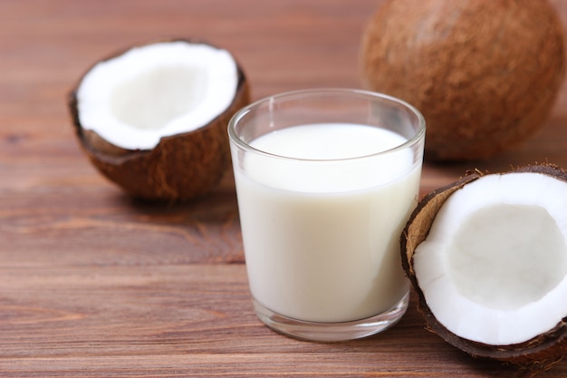 Milk and broken coconuts on the table vegetable milk a veggie drink