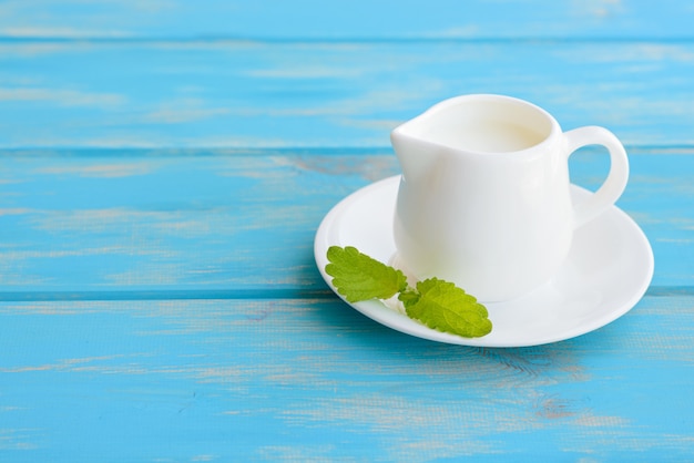 Milk in ceramic ware on a wooden table