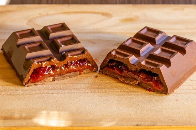 Milk chocolate bar filled with dulce de leche peanuts and strawberry