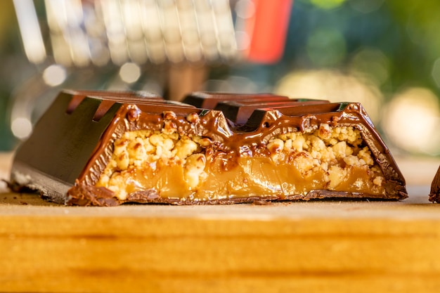 Milk chocolate bar filled with dulce de leche peanuts and strawberry