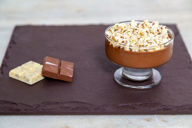 Milk chocolate mousse with chocolate shavings.