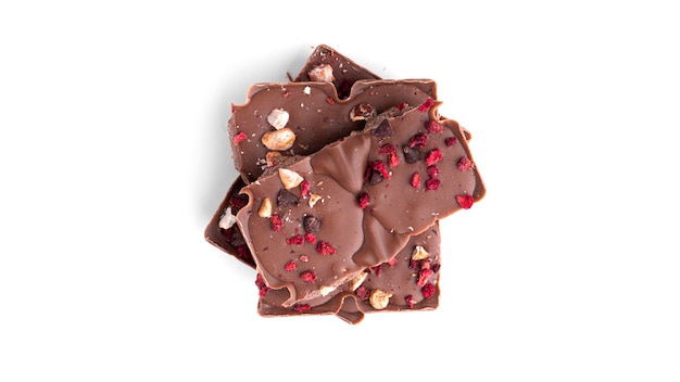 Photo milk chocolate with berries and nuts isolated.