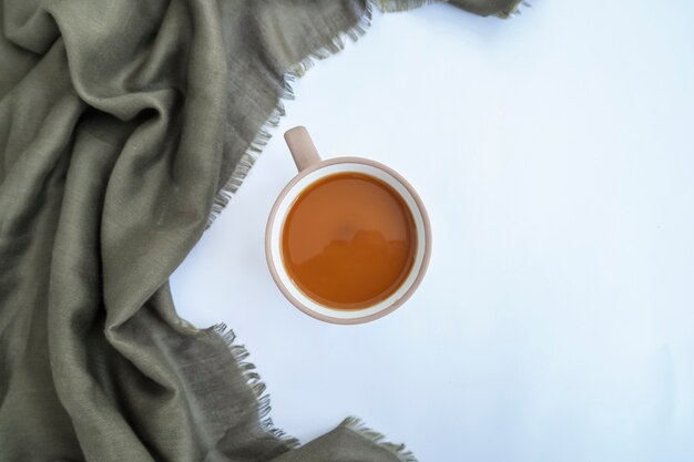 Milk coffee and green scarf isolated on white background, minimal concept idea.