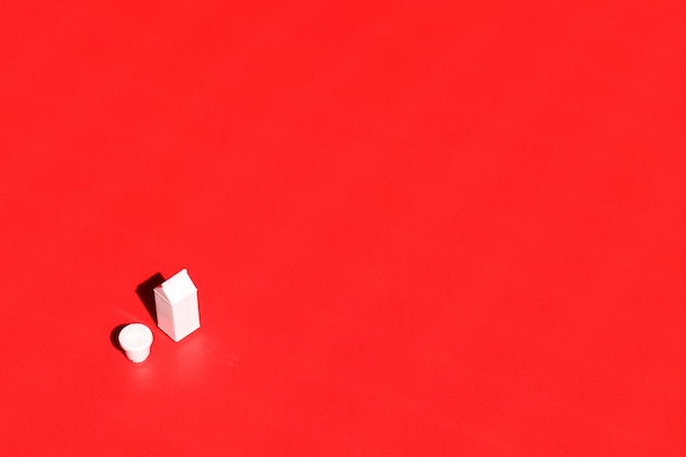 Milk container on red background