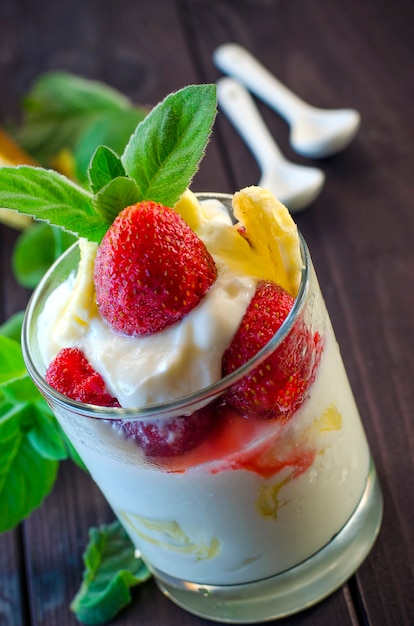 Milk dessert with strawberry and banana closeup