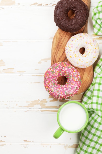 Milk and donuts on wooden table