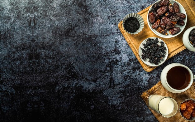 Milk dried dates fruit and apricot on dark background