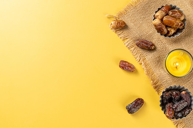 Milk dried dates fruit and apricot on yellow background