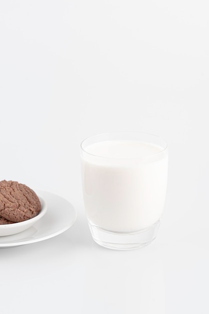 Milk glass and chocolate cookies on a white background,