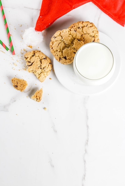 Milk glass and cookies for Santa Claus with Santa's hat