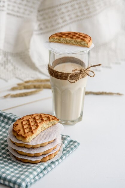 Milk in a glass and cookies on the table