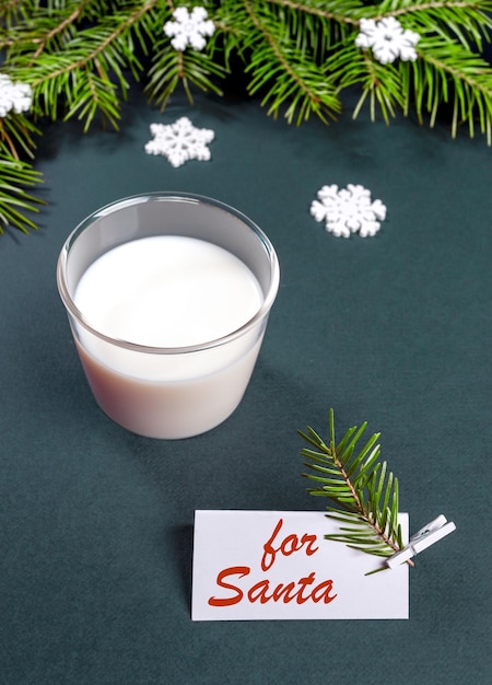 Milk glass for Santa Claus Xmas tree branches and note with red inscription For Santa on turquoise